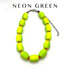Neon green beaded necklace on a white background with &
