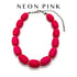 Neon pink beaded necklace on a white background with &