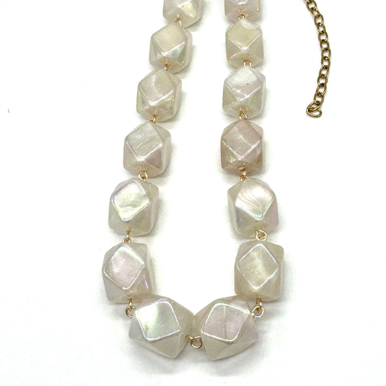 Necklace with large, faceted stone beads on a white background