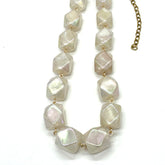 Necklace with large, faceted stone beads on a white background