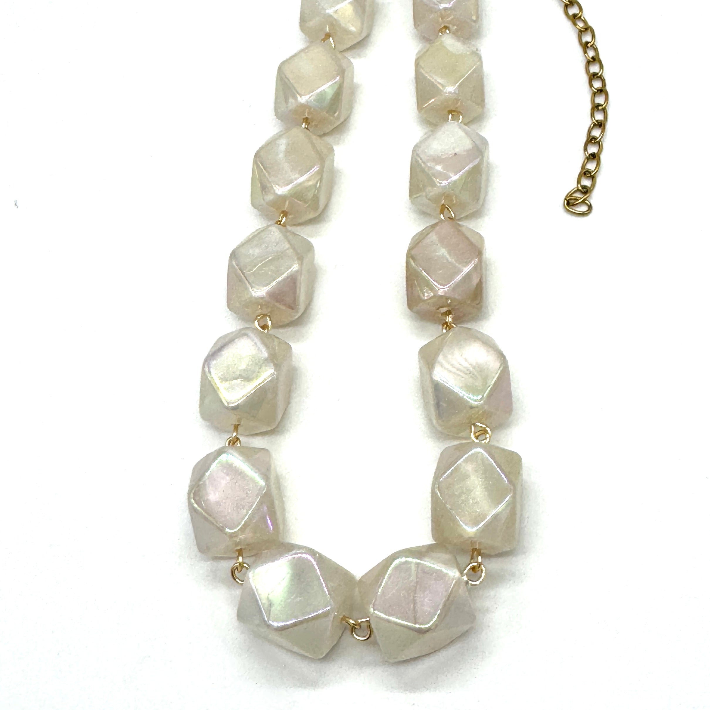 Necklace with large, faceted stone beads on a white background