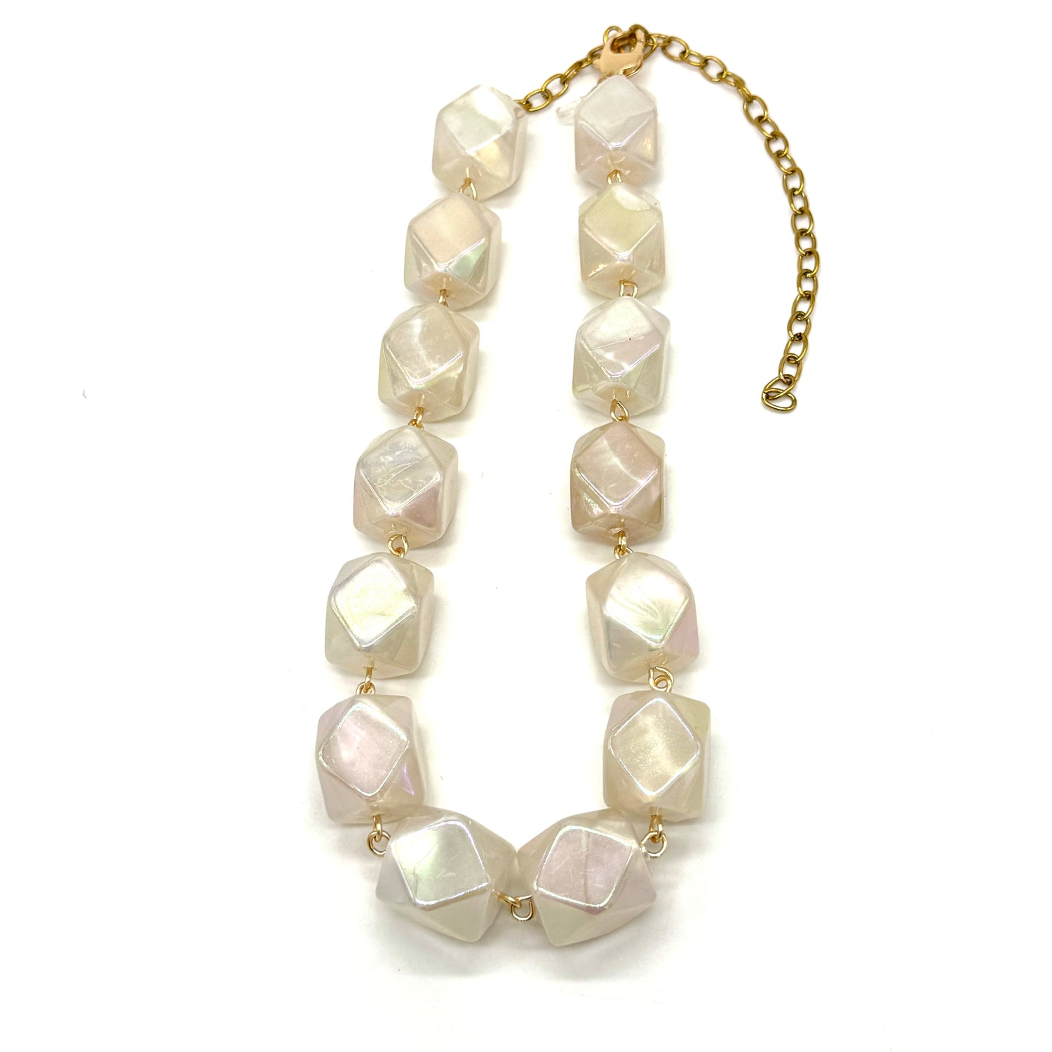 Necklace with large white beads on a gold chain against a white background
