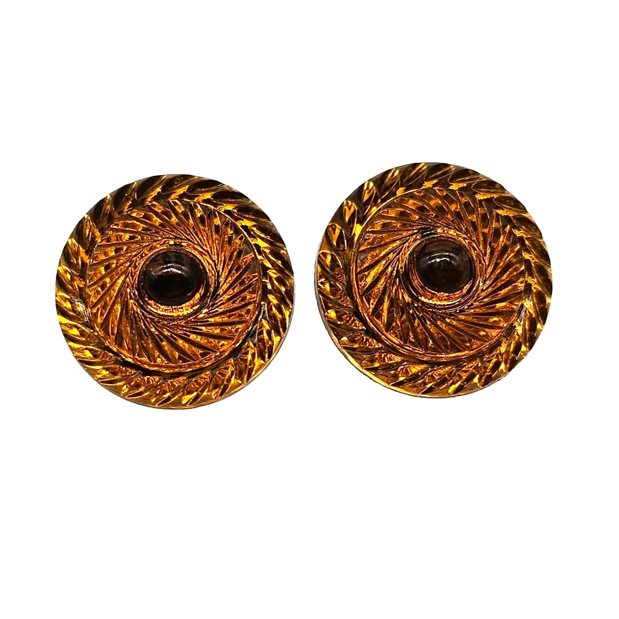 Pair of amber-colored circular earrings with intricate design on a white background