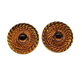 Pair of amber-colored circular earrings with intricate design on a white background
