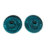 Two teak earrings with intricate patterns on a white background