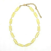 Necklace with yellow beads on a white background