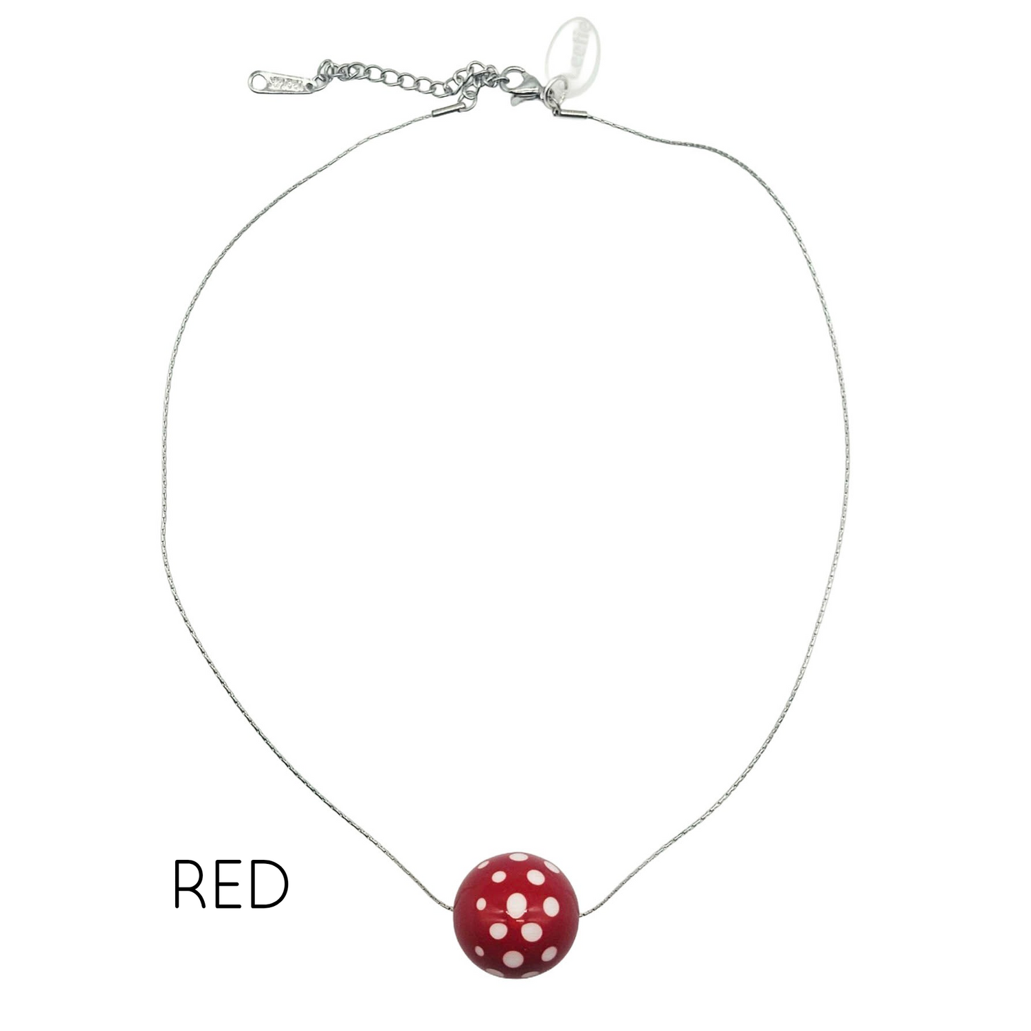 Necklace with a red and white polka dot pendant on a white background