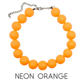 Neon orange beaded necklace on a white background with &