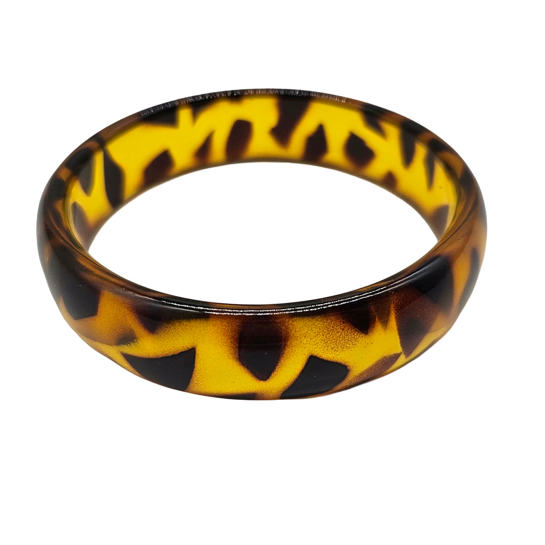 A glossy tortoiseshell bangle bracelet with a yellow and dark brown mottled pattern, shown on a plain white background.