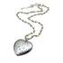 Heart-shaped silver pendant with a chain on a white background