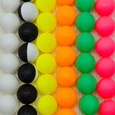 Colorful neon necklaces made with vintage lucite on a wooden background.