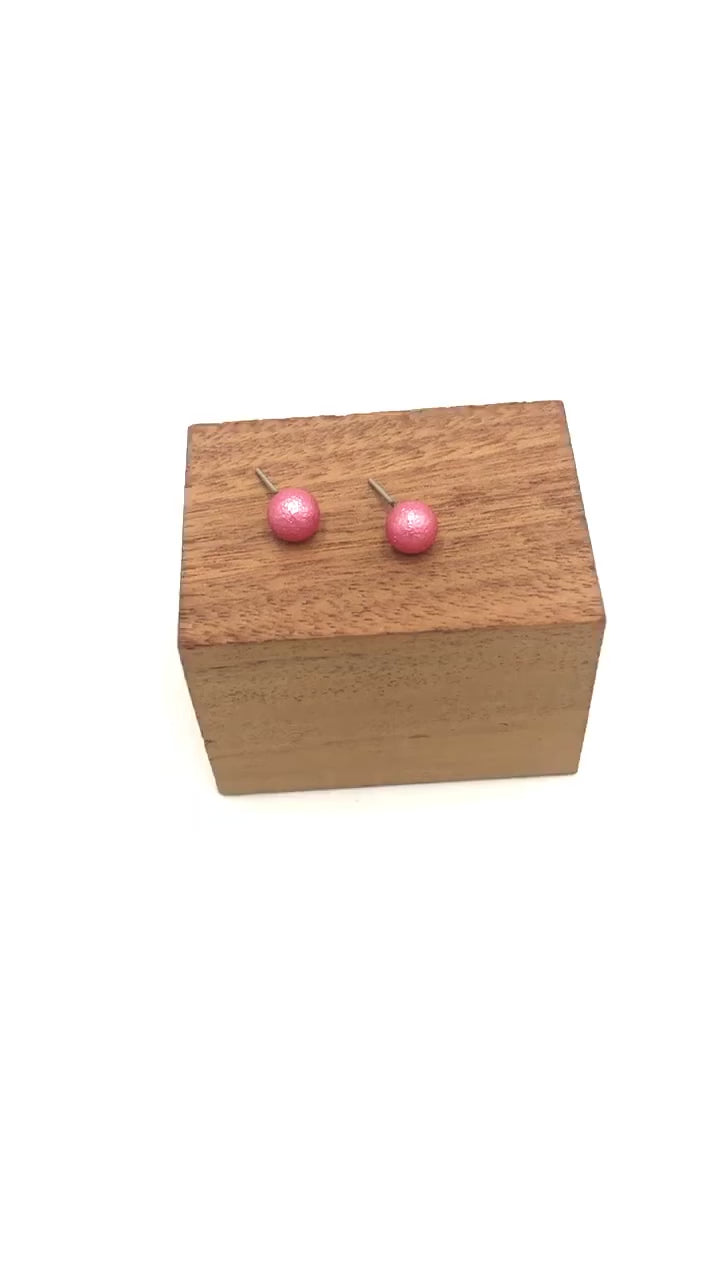 video of French pink pitted ball stud earrings