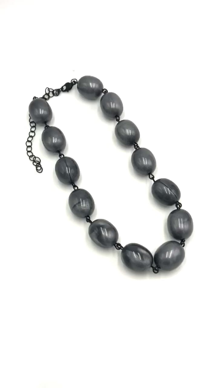video of oval shaped marble grey beaded necklace