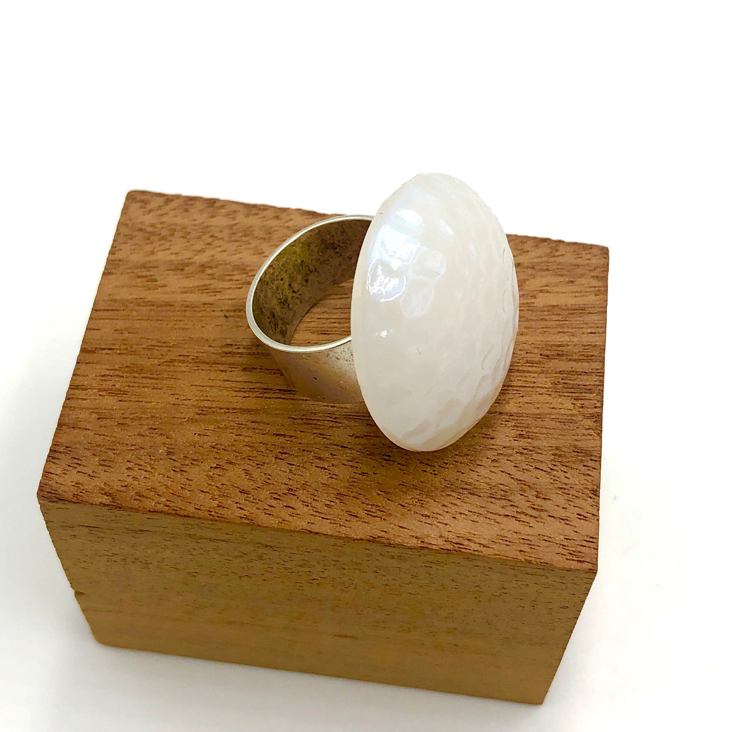 white dimpled cocktail ring on stand