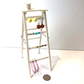 ladder with earrings on it